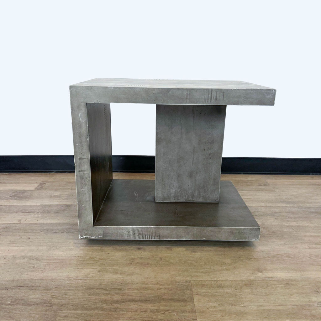 Vintage gray wood nightstand by Four Hands, with a concrete-like finish, displayed against a wood floor.
