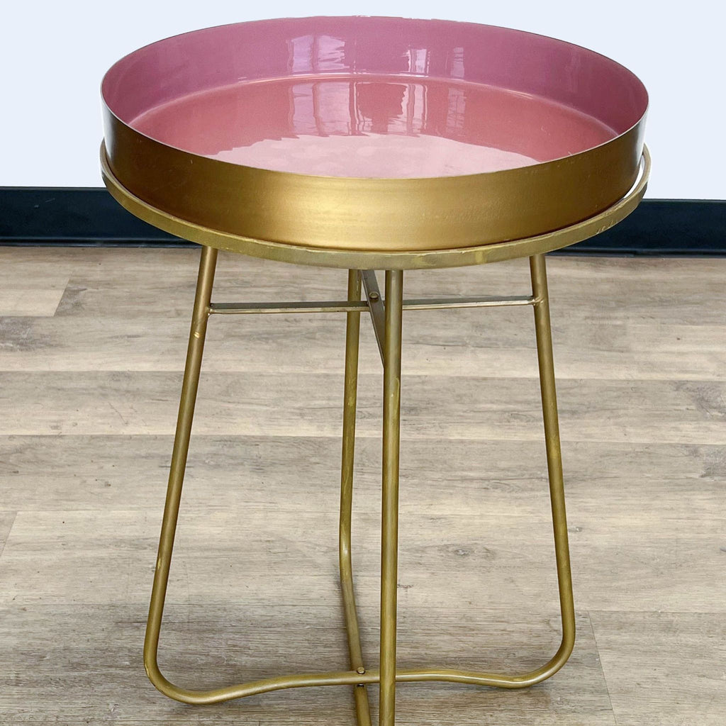 Round side table with pink top, gold frame, by Reperch.