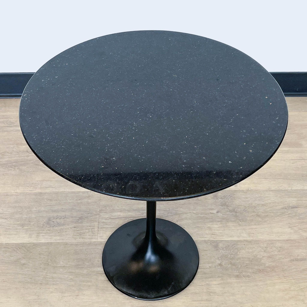 2. Close-up view of Reperch side & console table with speckled black fiberglass top and sleek pedestal.