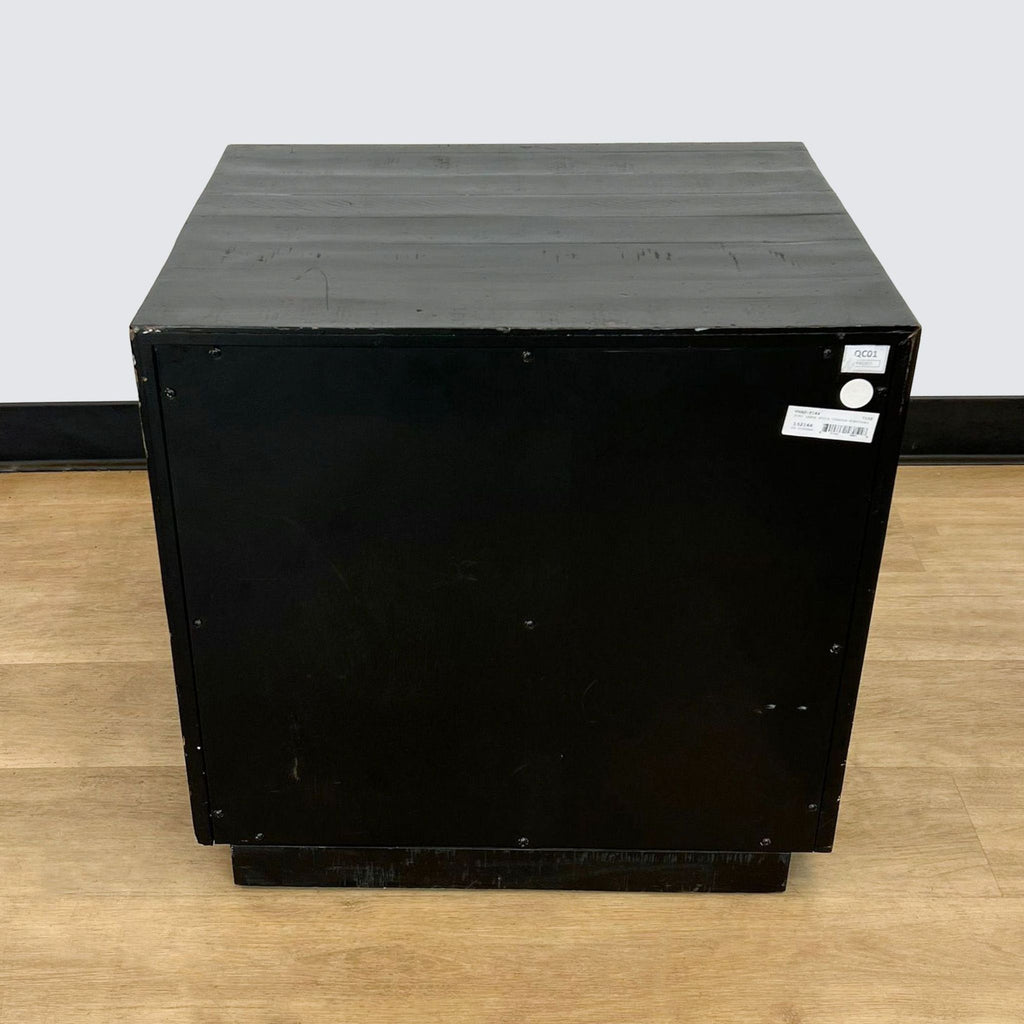 a black metal box with a white label on the front.