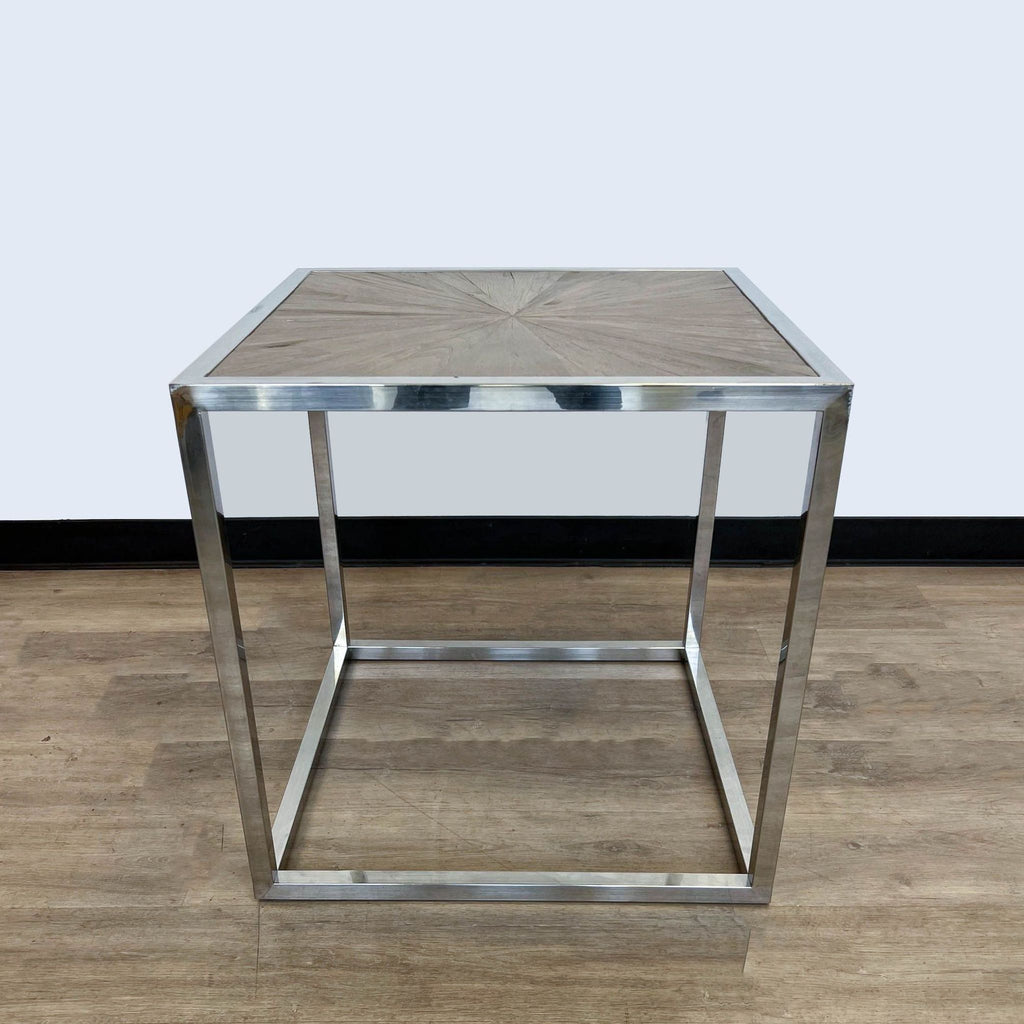 Brownstone Furniture end table with a starburst wood top and polished metal frame.