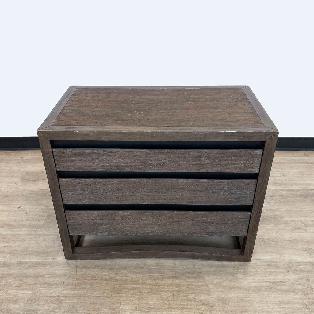 Brownstone Furniture end table with multiple drawers, closed view, on a light wooden floor.