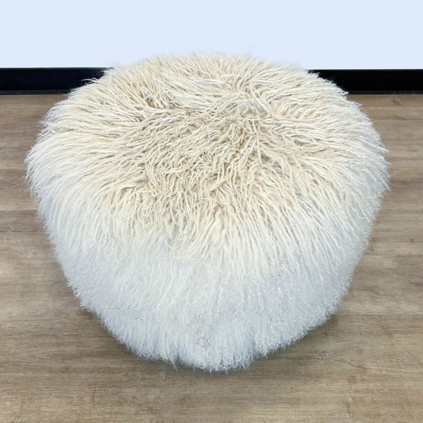 1. "20-inch H.D. Buttercup modern whimsical fur ottoman with a round, white Tibetan lamb exterior, shown on a wood floor."