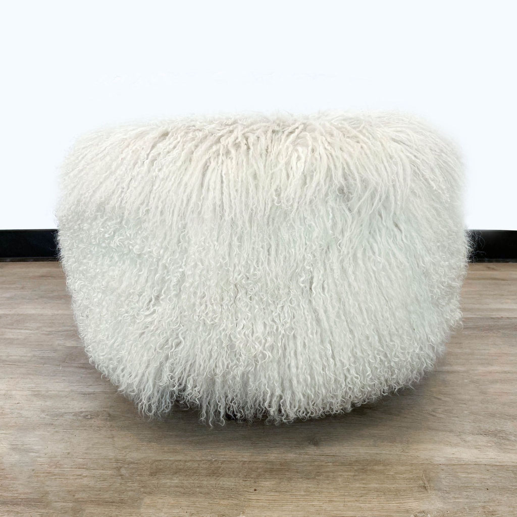 2. "Frontal view of a round, plush H.D. Buttercup Tibetan lamb fur ottoman in white, creating a cozy furniture piece."