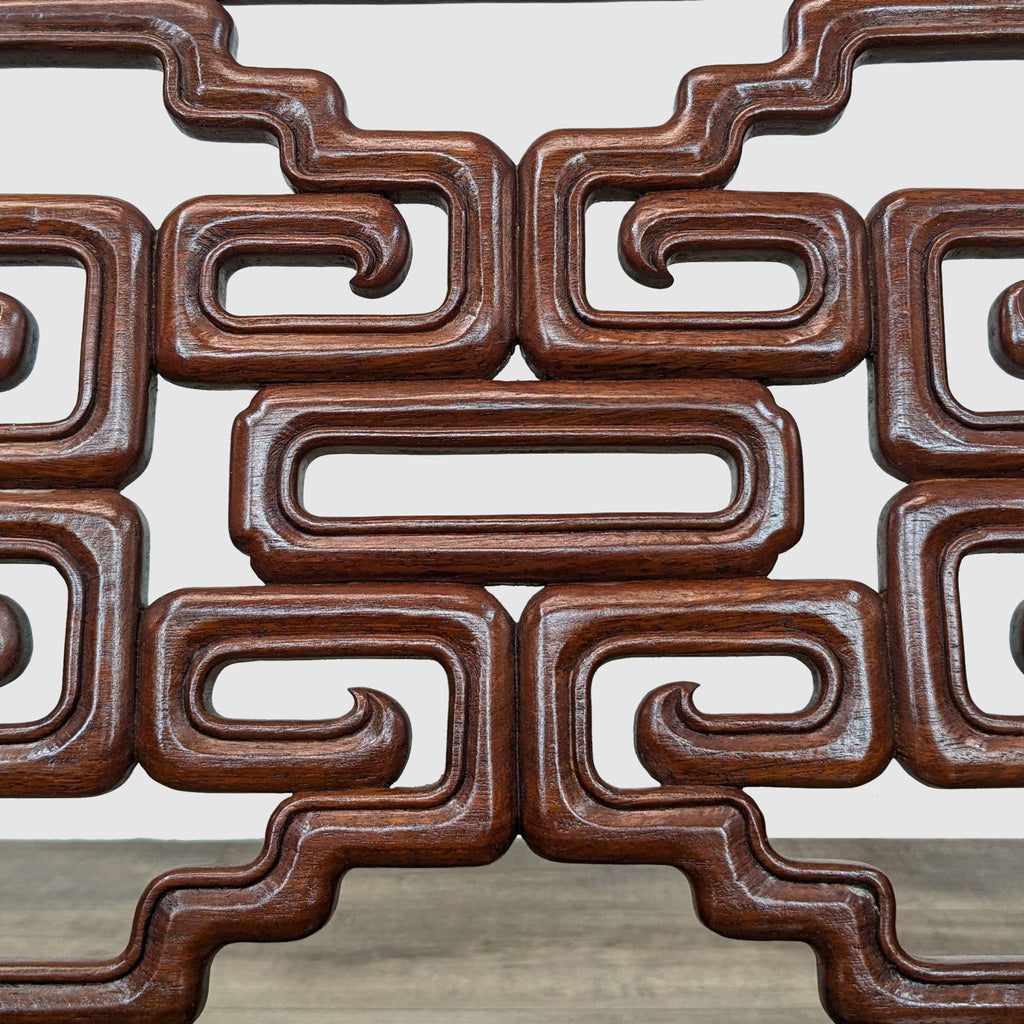3. Close-up of the ornate carved geometric patterns in the backrest of a Reperch rosewood lounge chair.