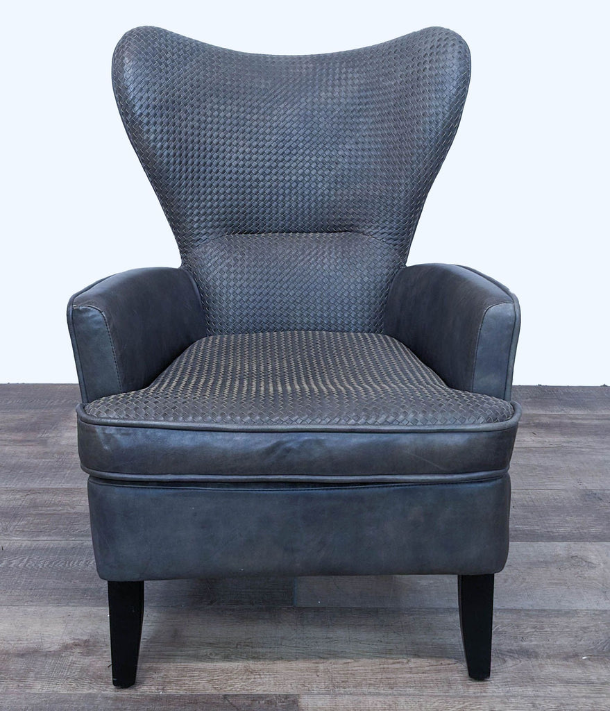 Front view of the Timothy Oulton Mentor leather chair, featuring woven and smooth textures with a zip detail on the back.