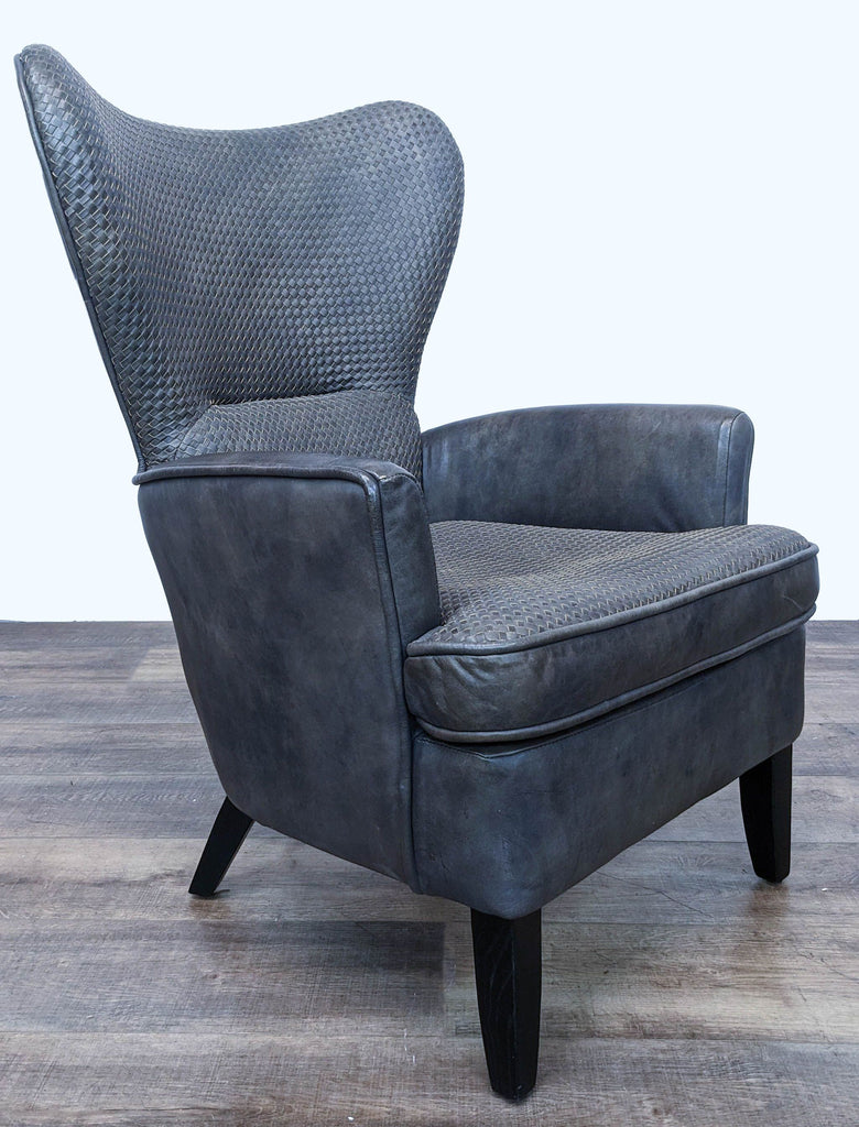 Three-quarter view of the Timothy Oulton Mentor chair in a lounge category, displaying its elegant wingback design and texture contrast.