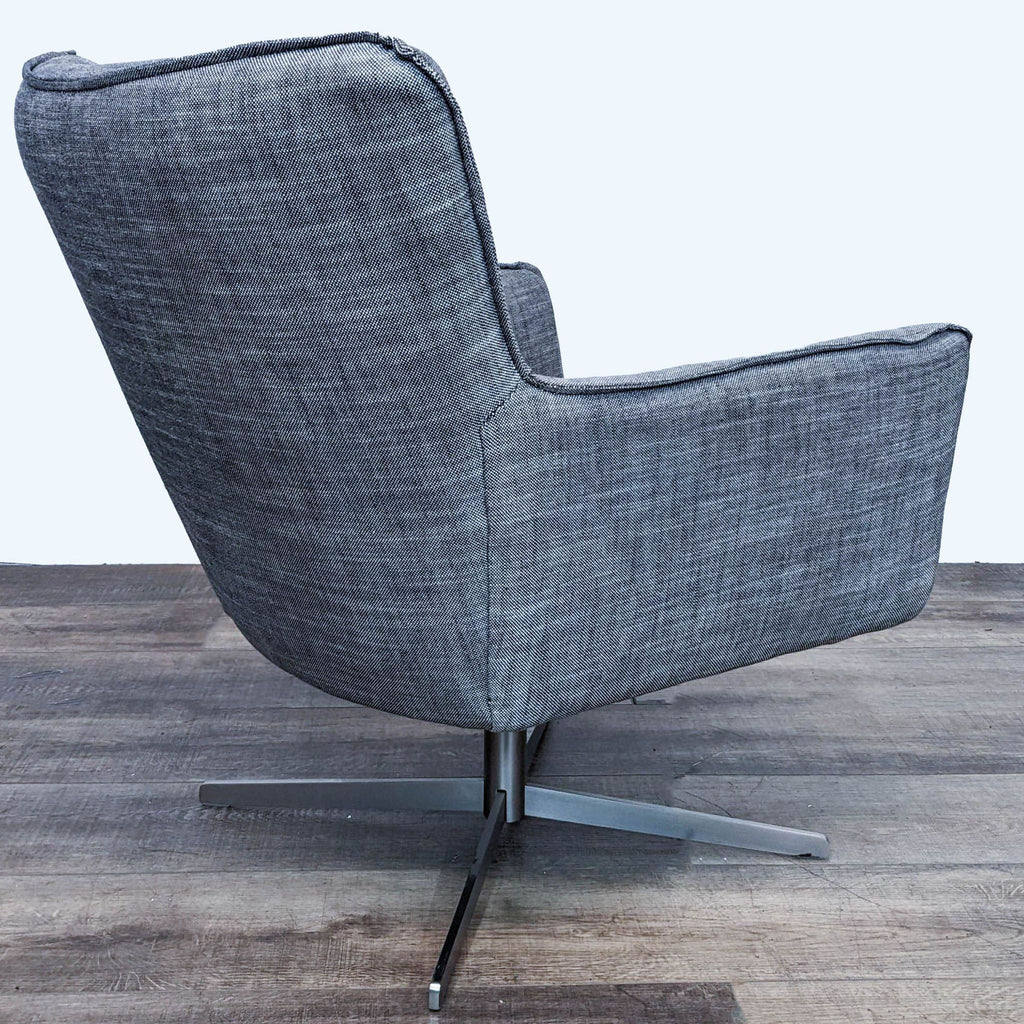 2. Side angle showcasing the sleek profile of the gray Four Hands Jacob Chair with a wingback style atop a metal swivel base.