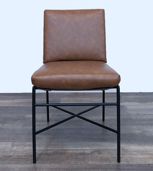 Modern Hearth & Hand with Magnolia dining chair with brown faux leather and metal frame, front view.
