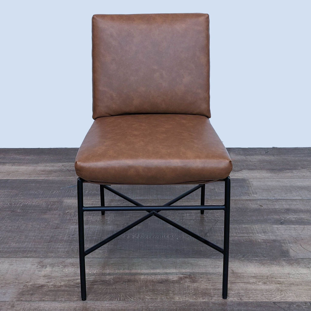 Elegant brown faux leather dining chair by Hearth & Hand with Magnolia, displaying its metal frame and comfortable backrest.