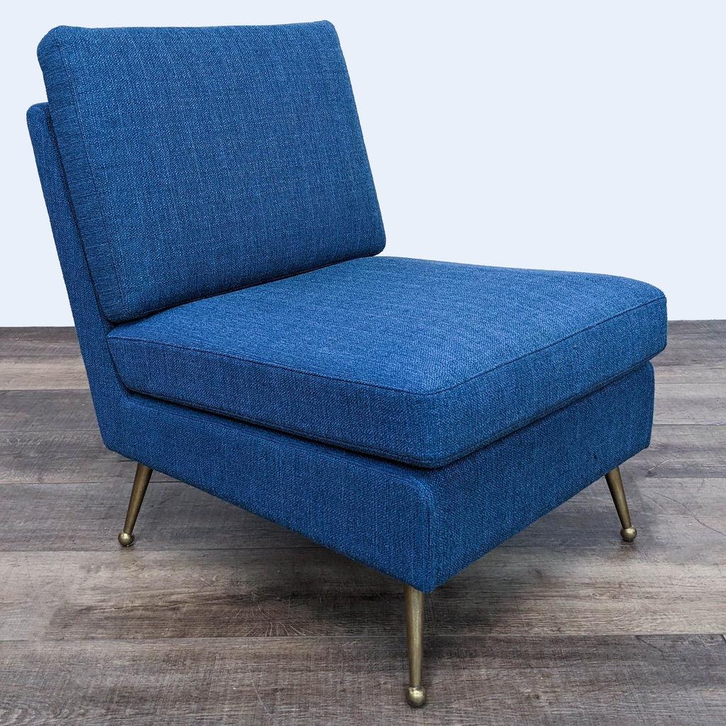 MXM stylish and comfortable navy blue fabric lounge chair with golden legs, three-quarter view.