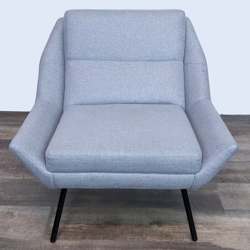 3. Three-quarter view of The Z Chair from HD Buttercup, featuring the well-padded seat and supportive backrest in light grey fabric.