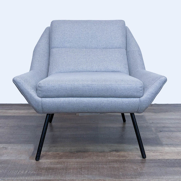1. Front view of The Z Chair by HD Buttercup, showcasing a minimalist light grey lounge chair with black metal legs.