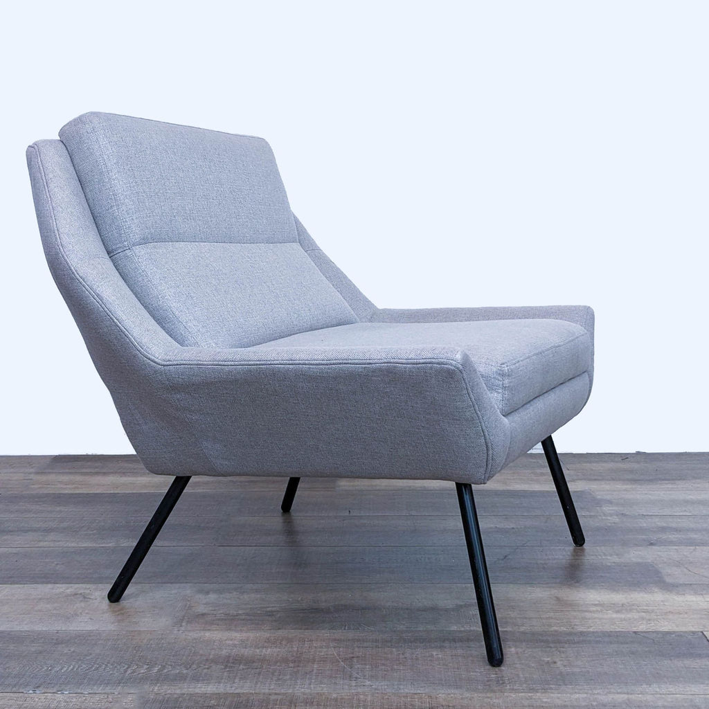 2. Side angle of The Z Chair by HD Buttercup, highlighting the sleek design and comfortable angle of a grey upholstered seat.
