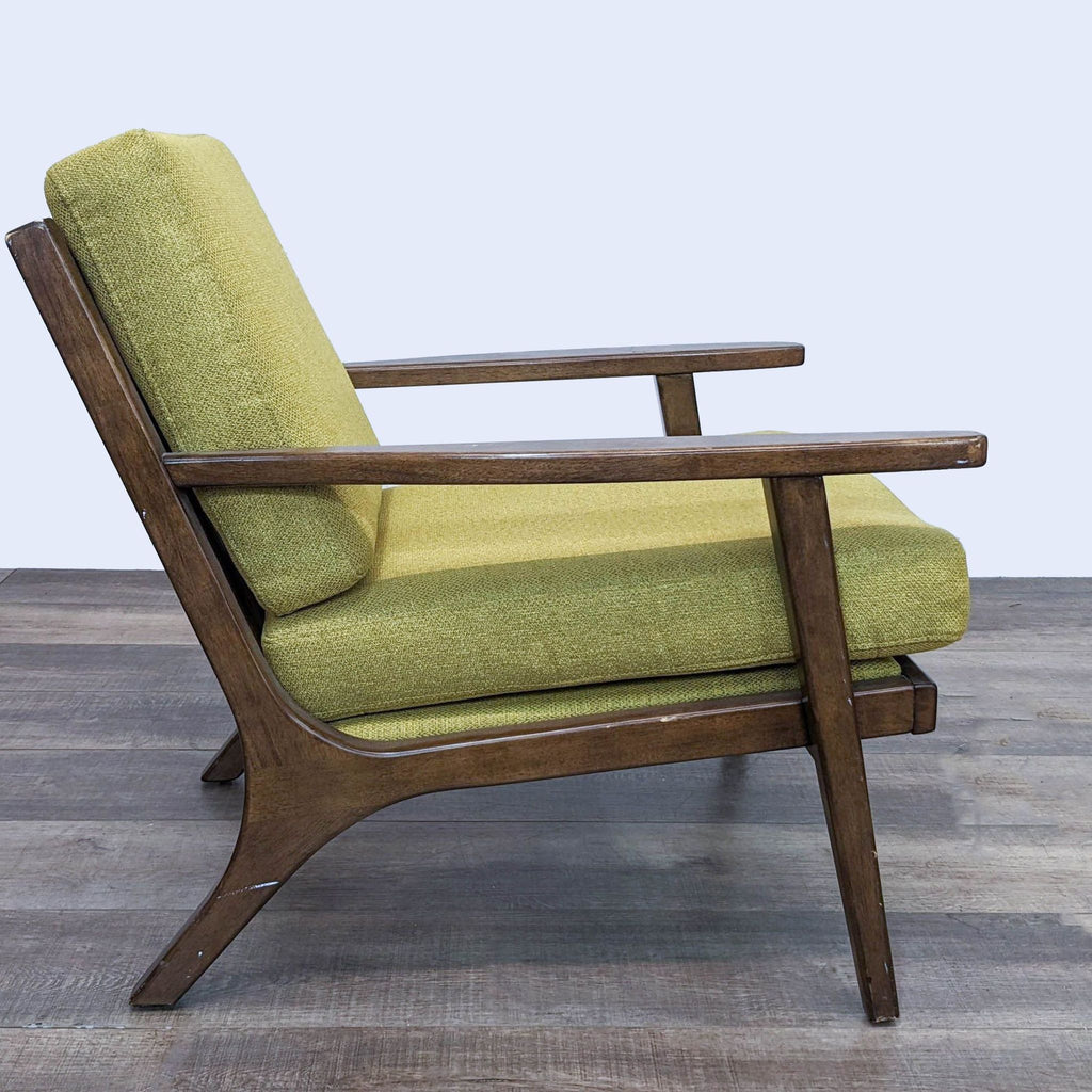 Side angle of the Xander lounge chair showcasing its wooden frame and angled design, with yellow-green upholstered cushions.