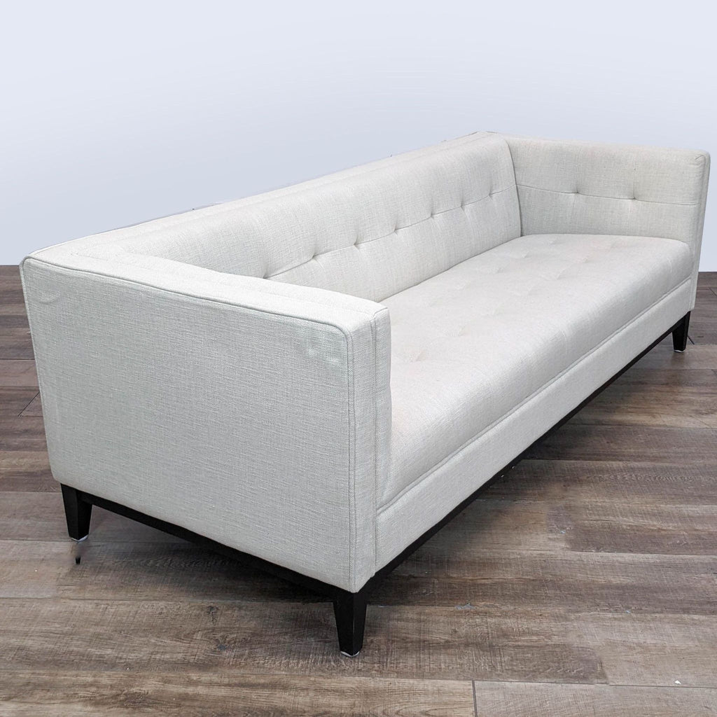 Side-angle view of a fabric upholstered Gus Atwood Sofa showcasing its clean lines and sophisticated look.