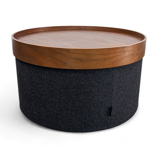 1. Design within Reach coffee table with a wooden removable tray top on a dark fabric base.