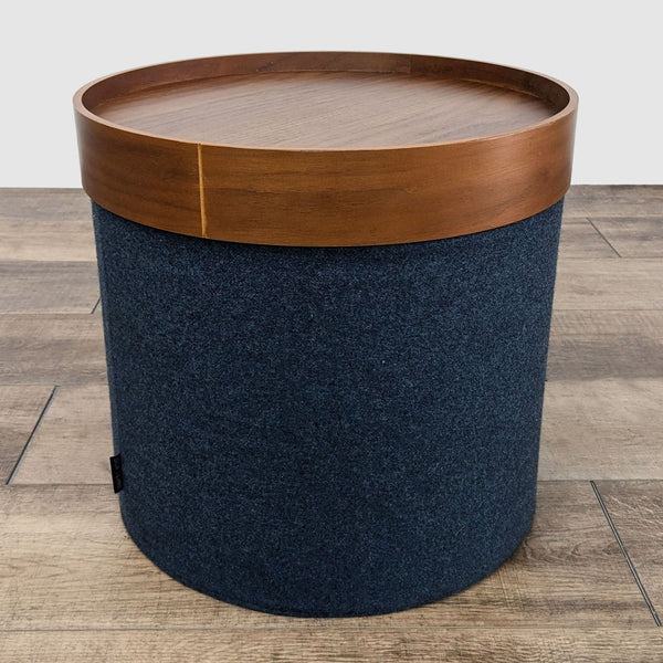 1. Design within Reach coffee table featuring a removable round wooden tray on a blue fabric base.