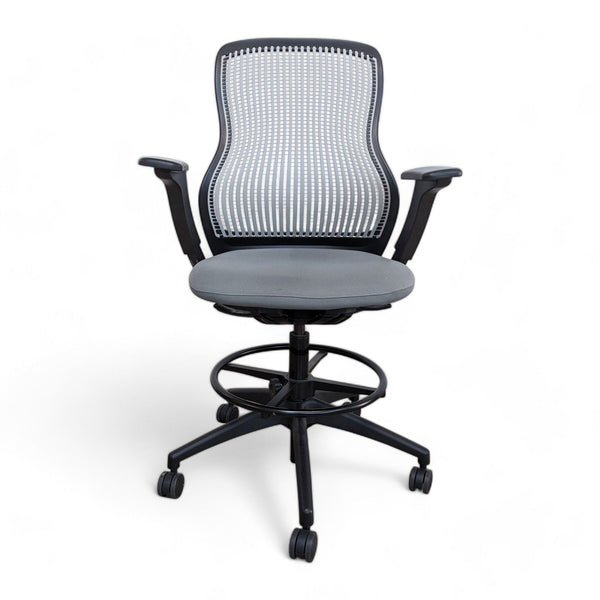 Knoll brand ergonomic office chair with mesh back and cushioned seat on wheels, isolated on white background.