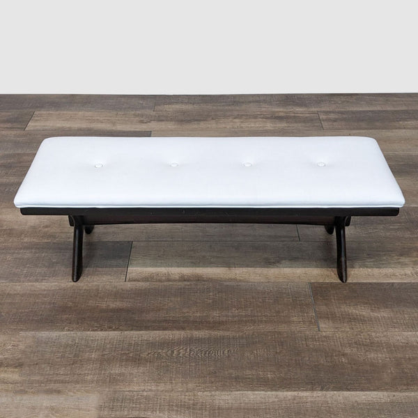Reperch white leather-look tufted bench on a dark frame, front view on wooden floor.