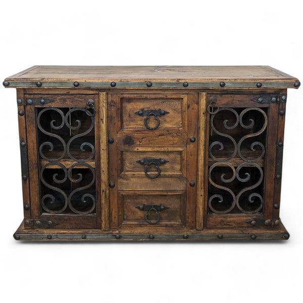 Rustic Chilean pine buffet by Pueblo Viejo Imports with wrought iron door fronts on a white background.