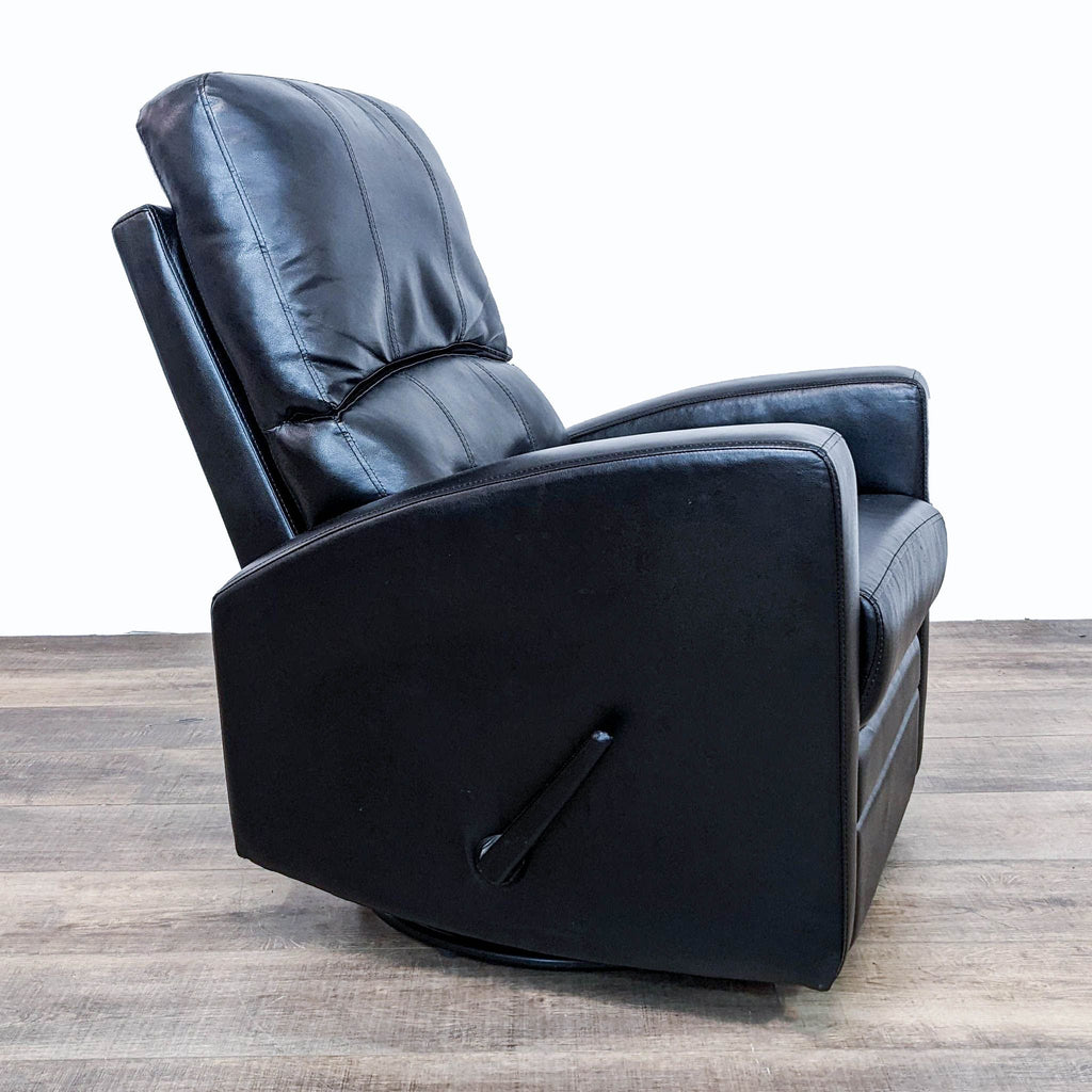 Side angle of black faux leather recliner in upright position.
