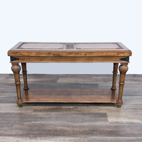1. Reperch brand console table with recessed panel top, raised carving, and metal accents, against a wood floor.