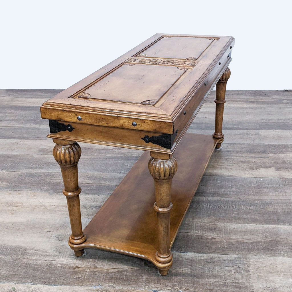2. Angled view of a Reperch side table showcasing the recessed panel design, ornate carving, and metal hardware.