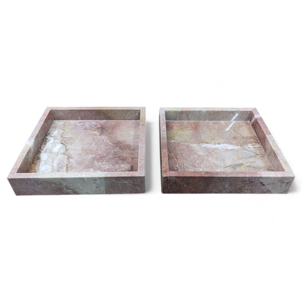 Pair of stackable pink marble trays by CB2, shown side by side on a white background.  