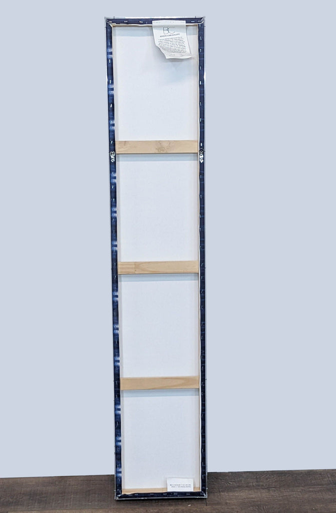 Alt text 3: The back of "Fallen Textile #1" by C. Benson-Cobb, displayed on canvas with protective wooden supports and a label, indicating it's by Reperch.