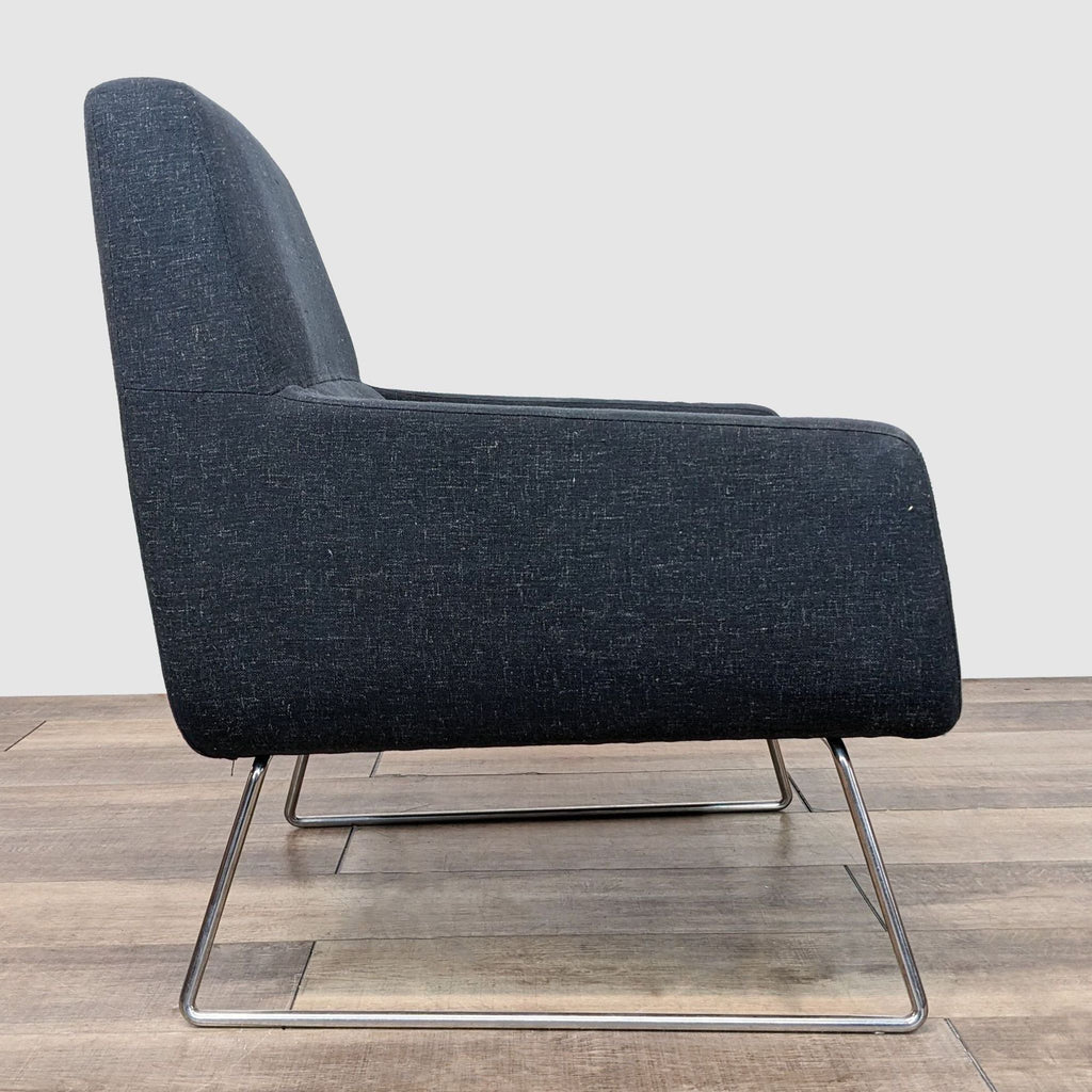2. "Side view of a Reperch modern charcoal lounge chair with metal sled legs on a wooden floor."
