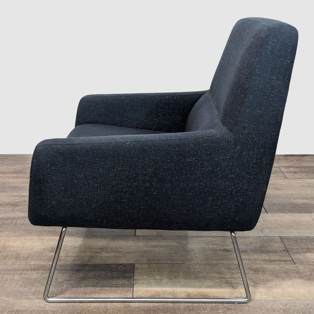 3. "Reperch brand lounge chair with dark upholstery and contemporary metal base, angled view highlighting seat depth."