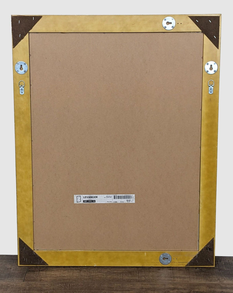 3. Back view of the Levanger mirror by IKEA, showing the brown backing board with mounting hardware and label.