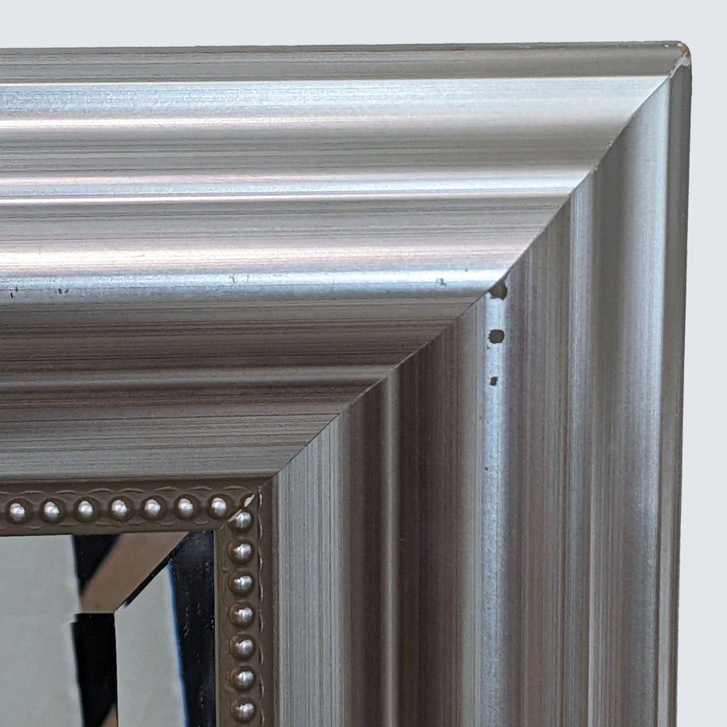 a silver frame with a mirror and a mirror