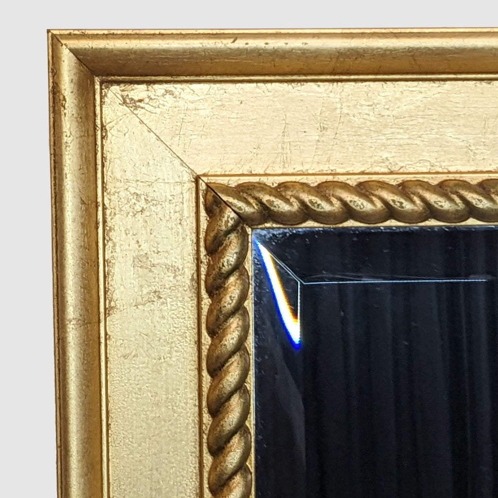 Close-up of gold wood frame detailing on a Reperch mirror.