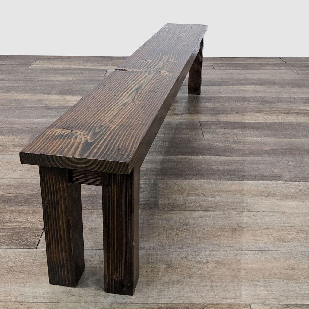 2. Side angle view of an Emmor farmhouse-style dining bench showcasing the wood texture and craftsmanship on a wooden floor.