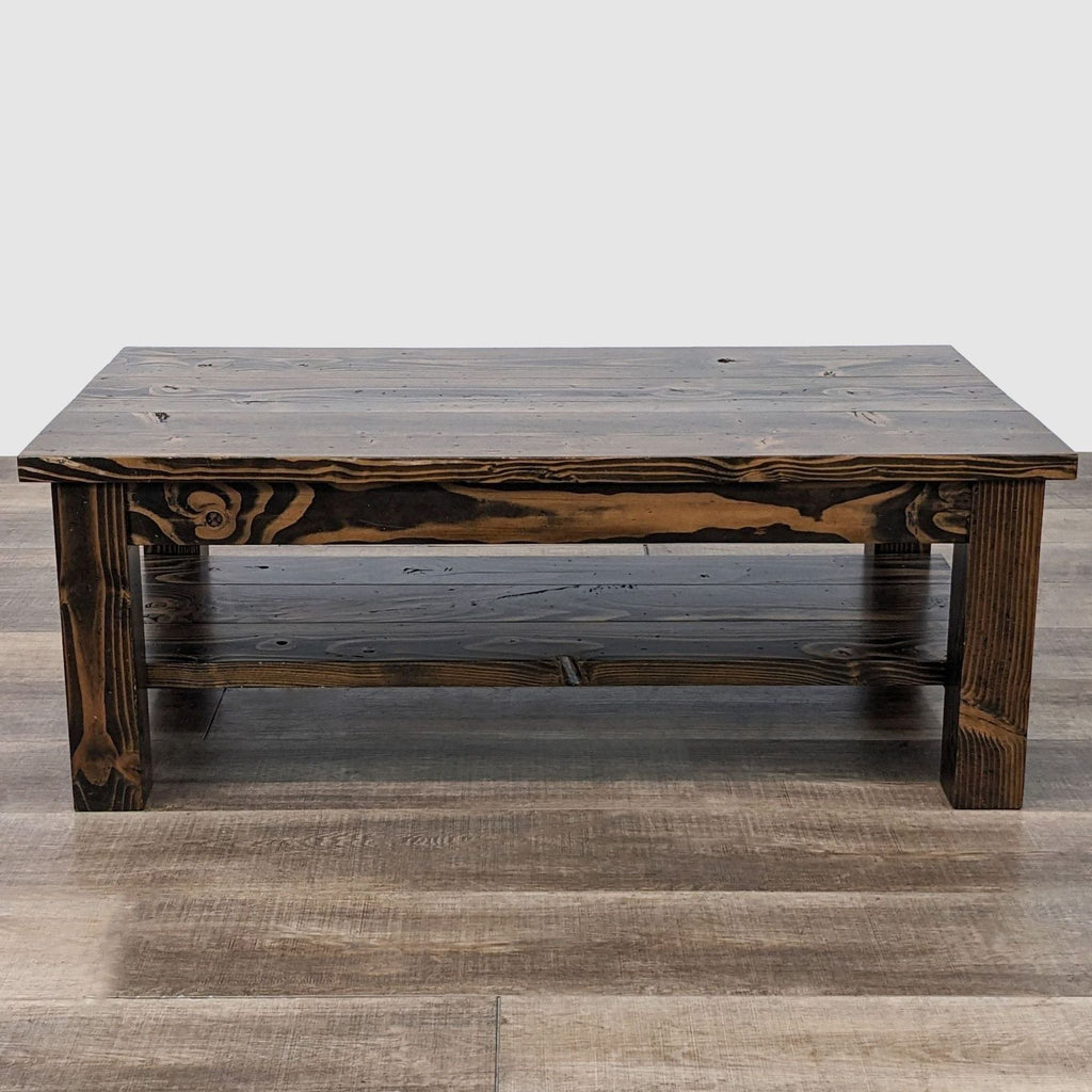 Handcrafted Emmor coffee table with natural wood pattern and dark stain, standing on wood flooring.