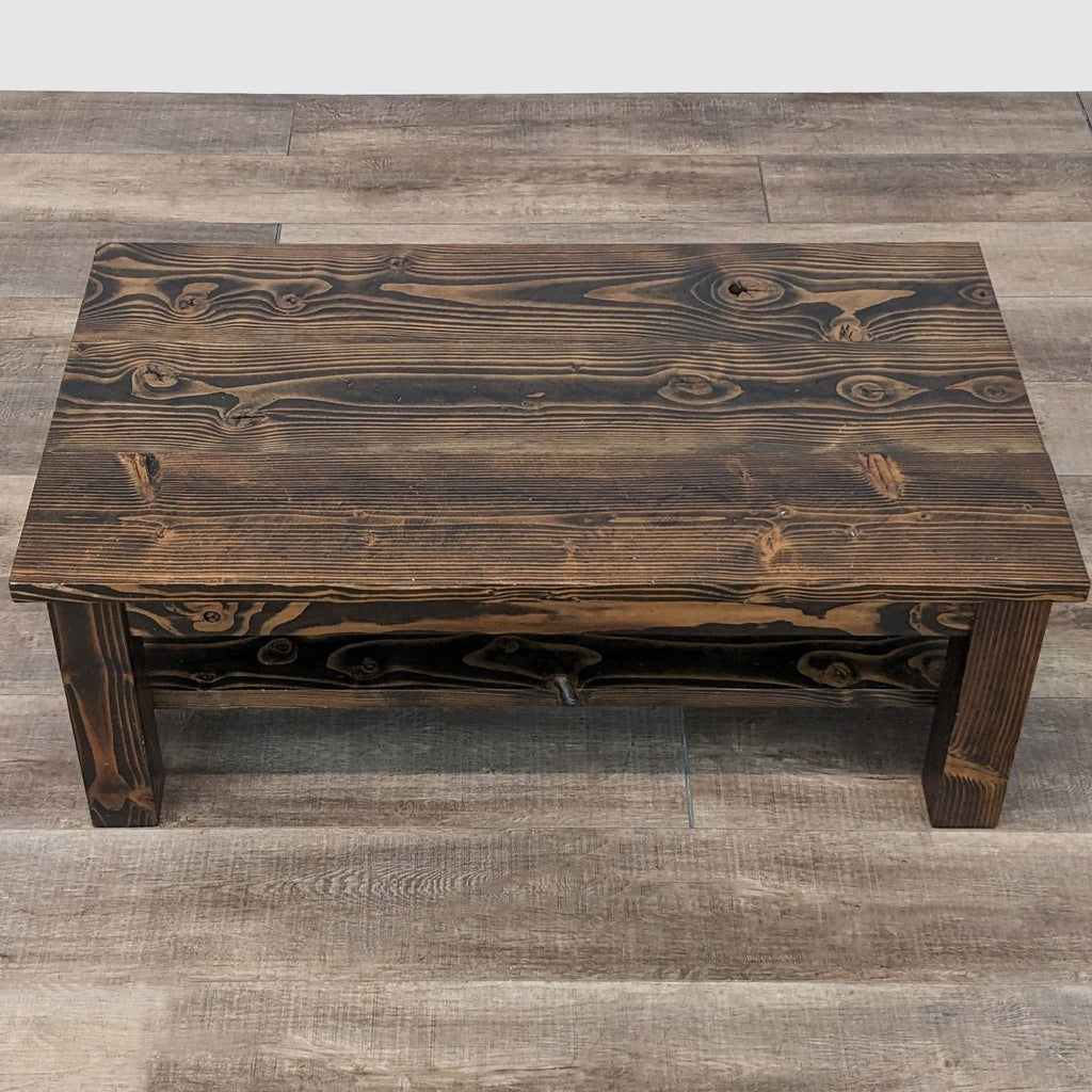 Rustic Emmor coffee table crafted from wood with distinctive grain patterns and knots, viewed from a high angle.