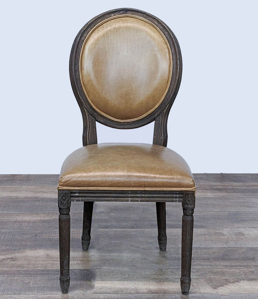 Reperch Vintage French Round dining chair with leather upholstery and carved wooden legs, front view.