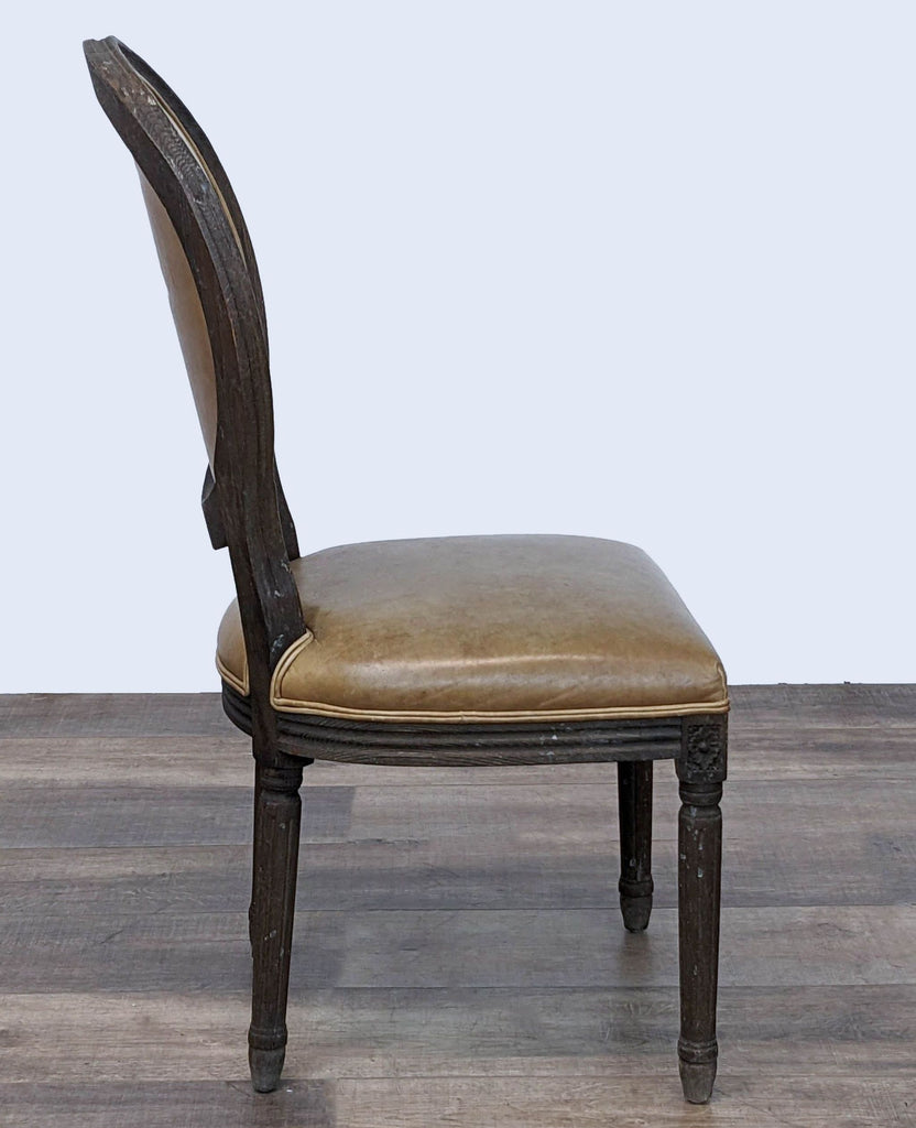 Side view of a Reperch Vintage French Round dining chair with linear form and nuanced carving details.