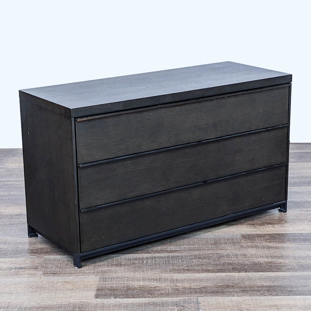 Minimalist style Reperch 3-drawer black dresser with clean lines against a wooden floor.