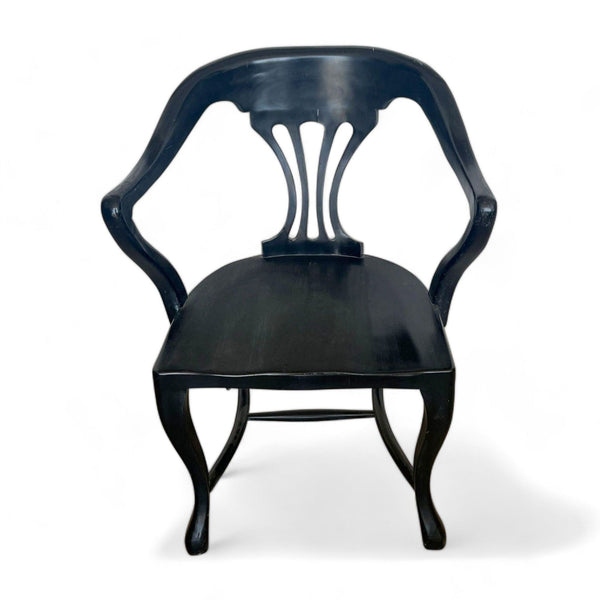 Reperch dining chair with a curved backrest and armrest in black lacquer finish against a white backdrop.