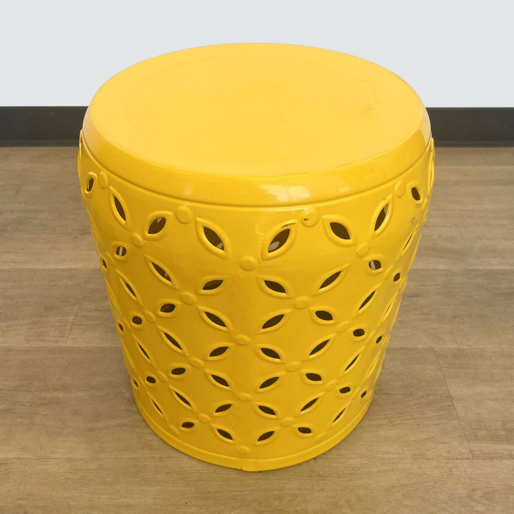 2. Reperch brand yellow console table with decorative holes, displayed on wooden flooring for a real-life look.