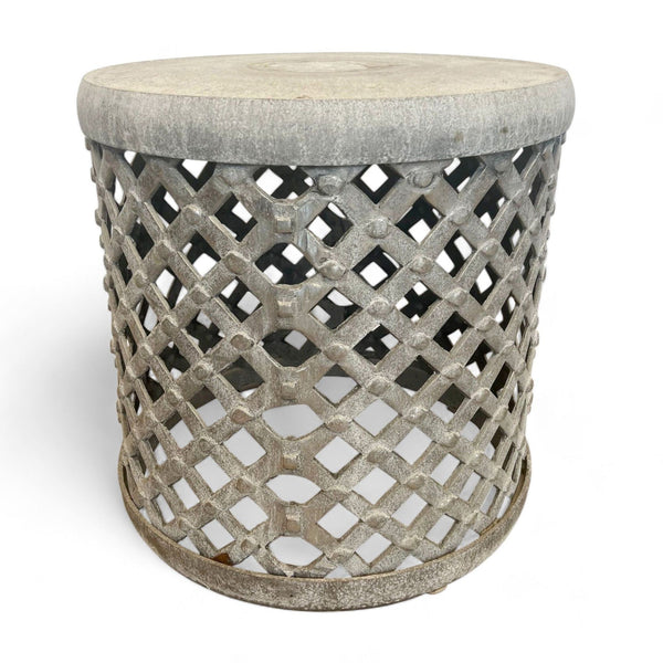 Round lattice metal side table with a solid top from Reperch against a white background.