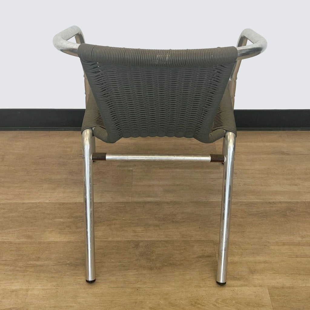 Back view of a Reperch dining chair featuring weather-resistant dark brown rattan and aluminum frame.