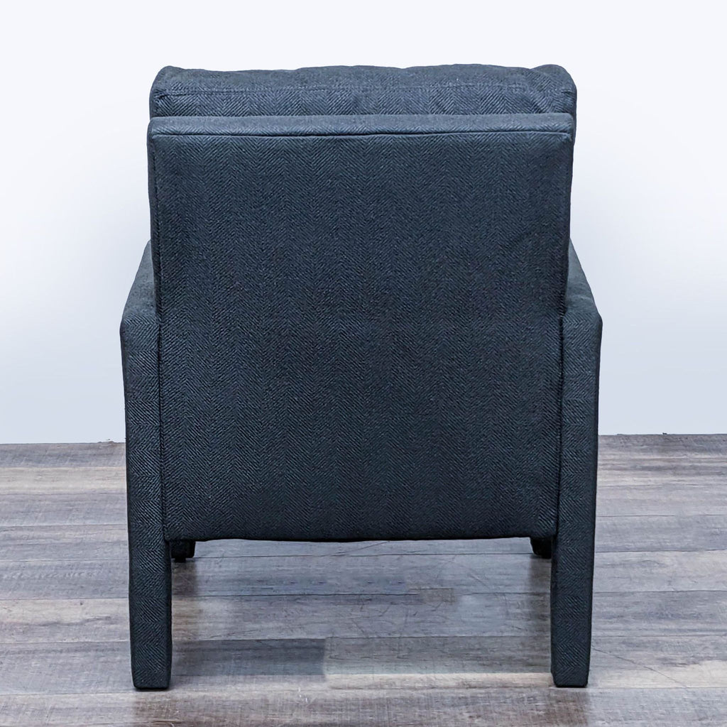 Rear view of HD Buttercup lounge chair, showing charcoal upholstery and back cushion detail.