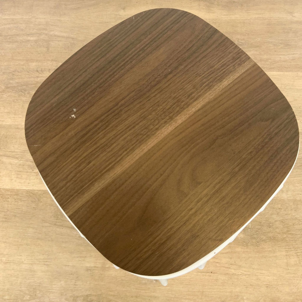 2. "Top view of a Reperch wooden side table with rounded edges on a wooden floor."