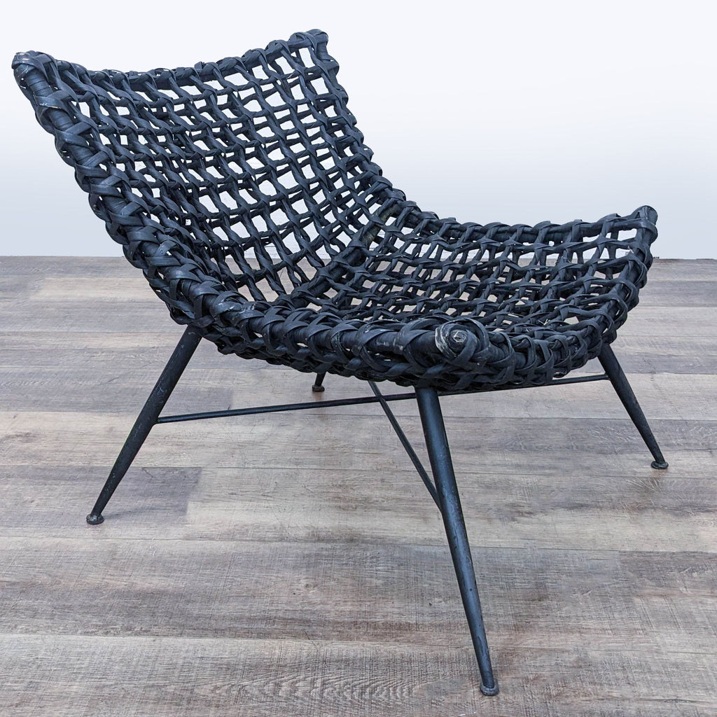 Angled view of a Reperch indoor wicker chair, showcasing its intricate weave and modern style.