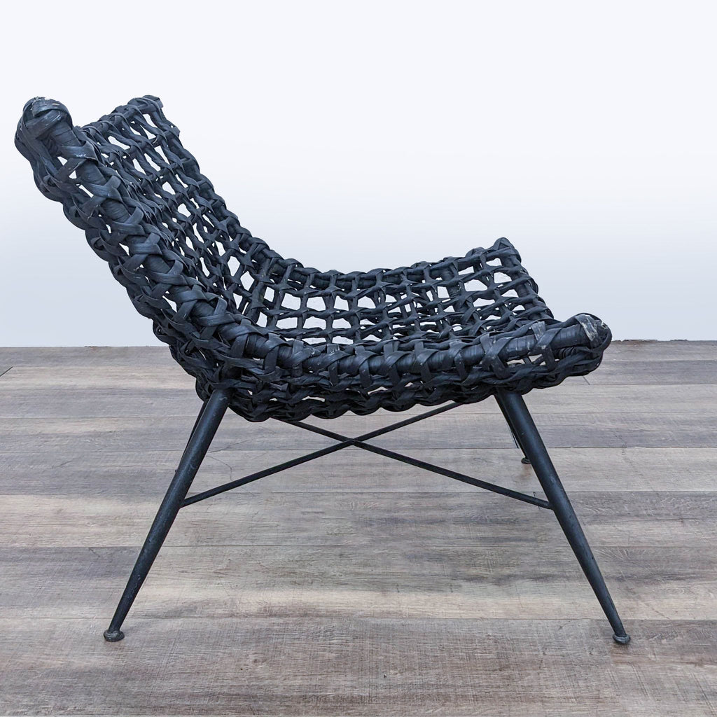 Side view of a contemporary Reperch wicker lounge chair, emphasizing its low profile and sleek legs.