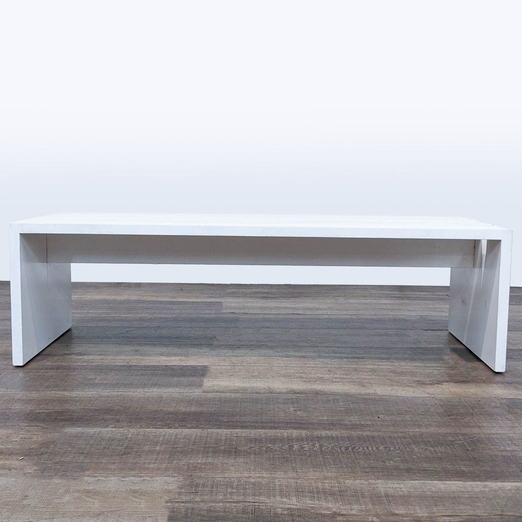 Minimalist white coffee table with straight lines on a wooden floor, by H.D. Buttercup.